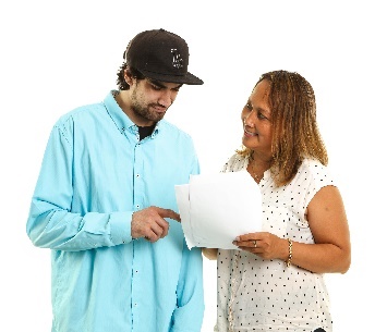 A man and a woman reading a document together. 