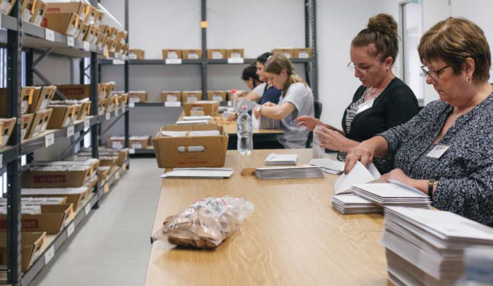 CPC STAFF PROCESSING APPROVED POSTAL VOTE BALLOT PACKS.